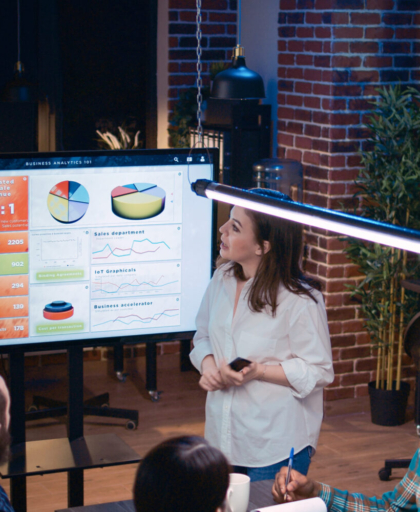 Team working on company research analytics presentation in business meeting, planning marketing strategy. Coworkers discussing sales statistics diagrams and charts at digital board